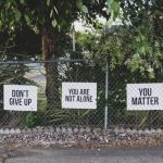 Mental Stimulation - don't give up. You are not alone, you matter signage on metal fence