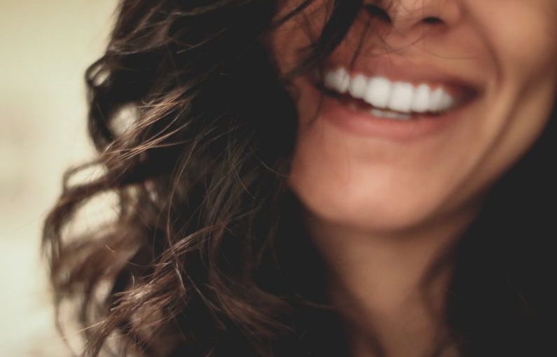Dental Care - long black haired woman smiling close-up photography