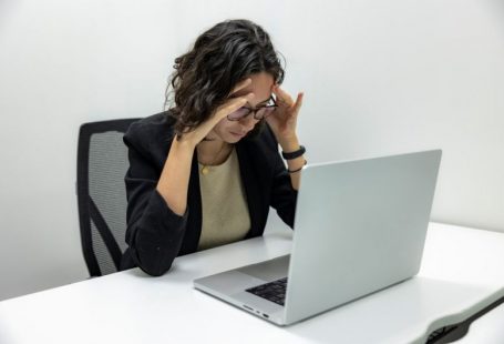 Health Issues - a woman sitting in front of a laptop computer