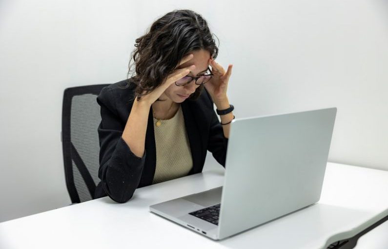 Health Issues - a woman sitting in front of a laptop computer