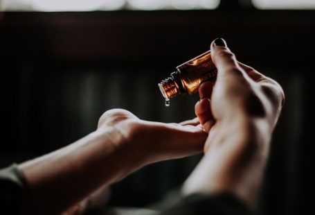 Care Tips - person holding amber glass bottle