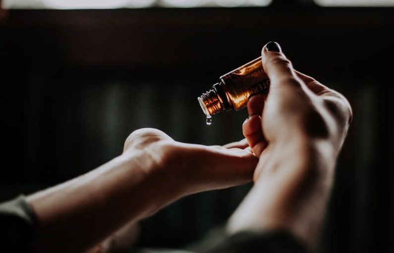 Care Tips - person holding amber glass bottle