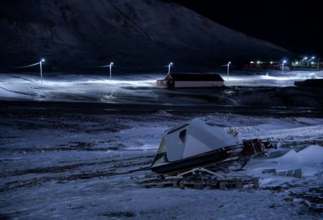 Emergency Exotic - a camper sits in the middle of a snowy field