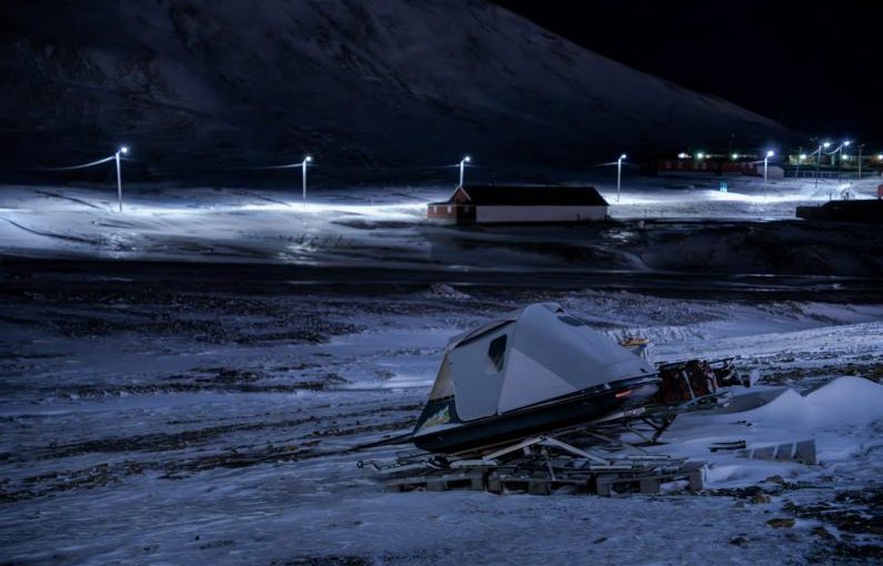 Emergency Exotic - a camper sits in the middle of a snowy field