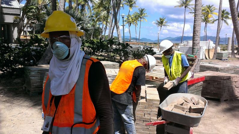 Safety Exotic - a group of people wearing safety vests and masks