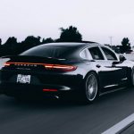 Insurance Exotic - running black Porsche sedan