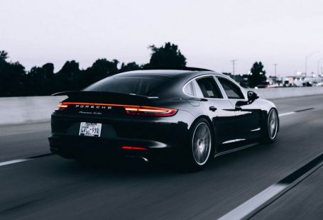 Insurance Exotic - running black Porsche sedan