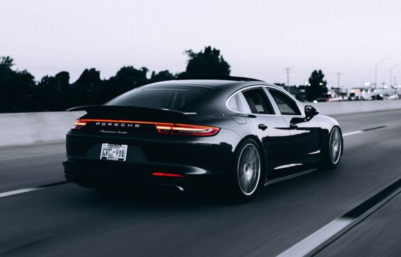 Insurance Exotic - running black Porsche sedan