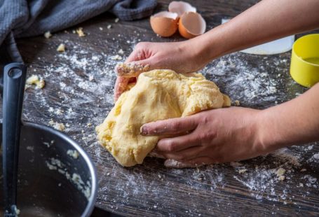 Homemade Food - person holding bread on brown wooden table