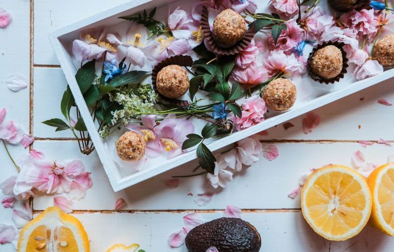 Healthy Treats - sliced oranges beside plate of round pastries