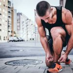 Exercise Benefits - man tying his shoes